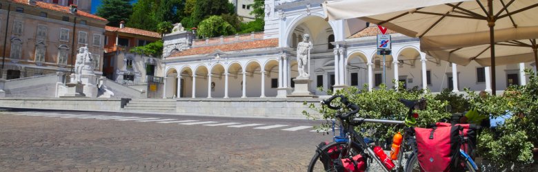 a bike in the middle of a city, with monuments around